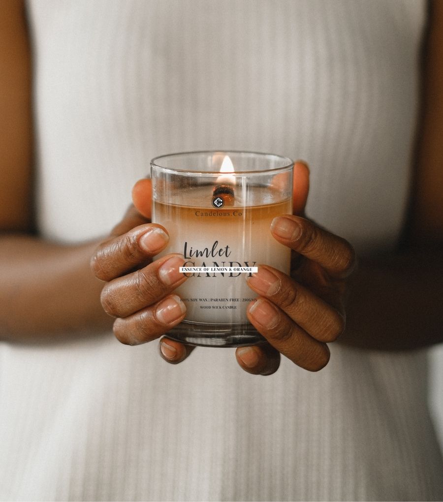 a women holding a candelous.co candle saying Clean Aromas Made to Enhance Your Self Care & Wellbeing